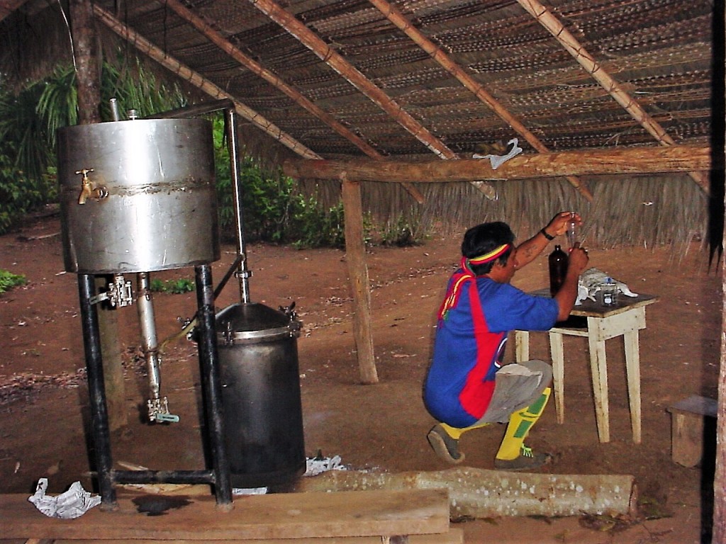 A worker purifies oil for the manufacture of indigenous cosmetics